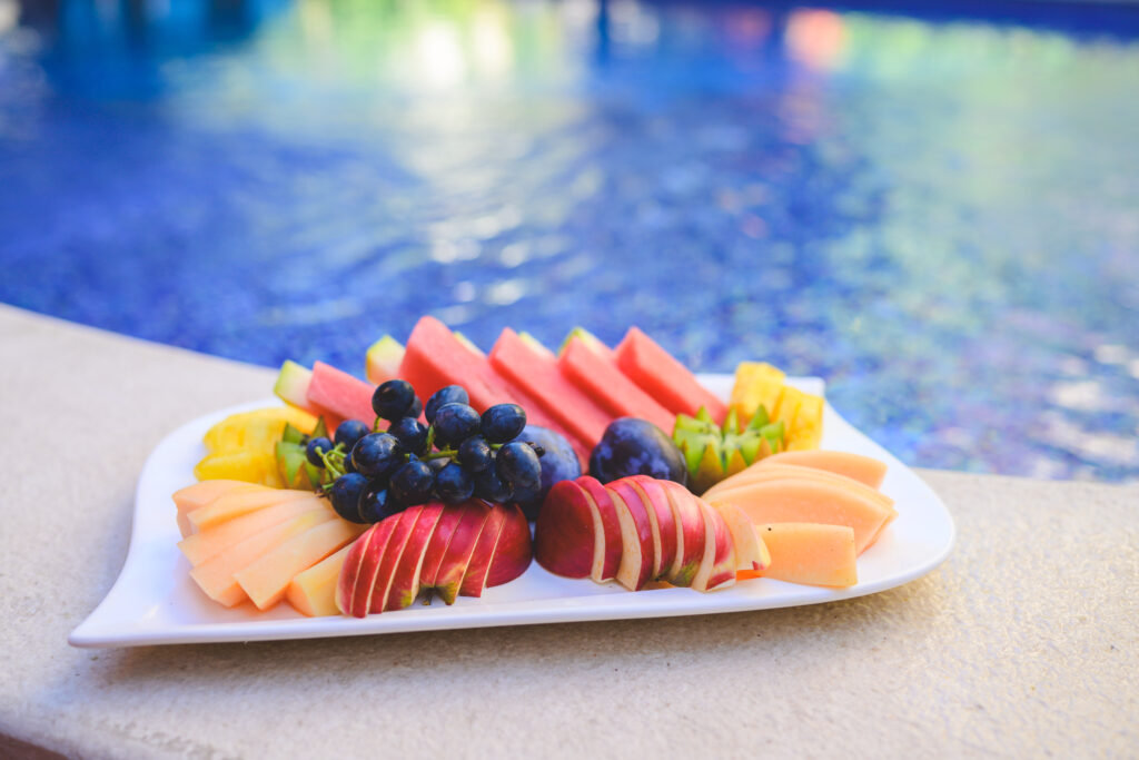 food served on plate by the pool
