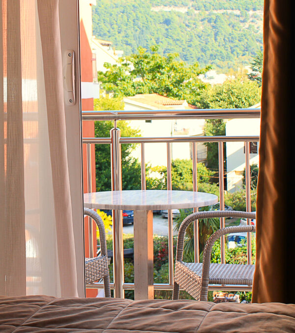Hotel room balcony view at mountains and buildings