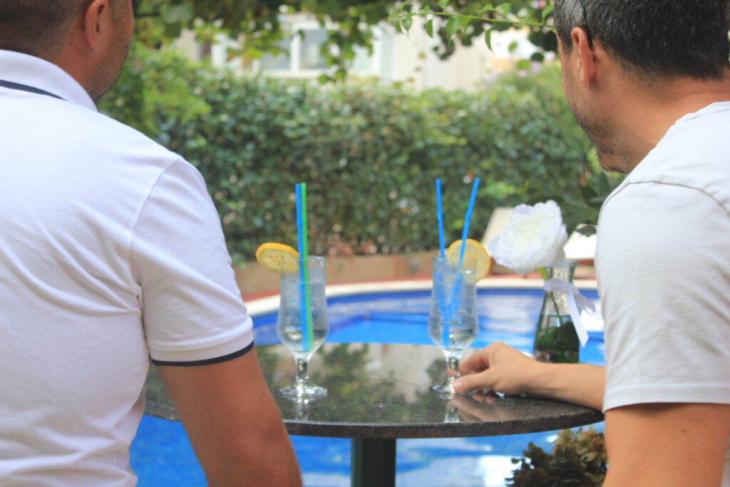 people relaxing and drinking by the pool