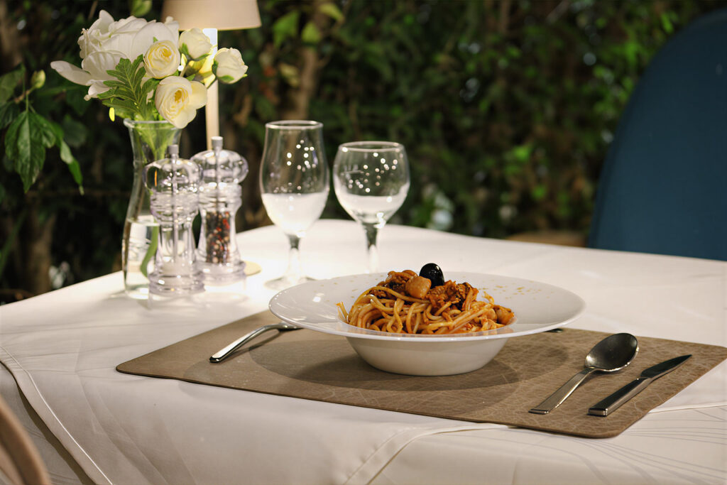 a plate of pasta served on a table in restaurant