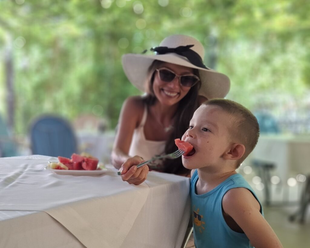 mom feeds her child with watermelon