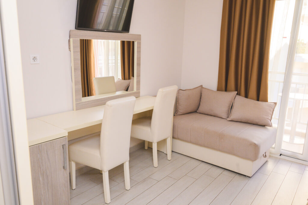 table with chairs and sofa in hotel room