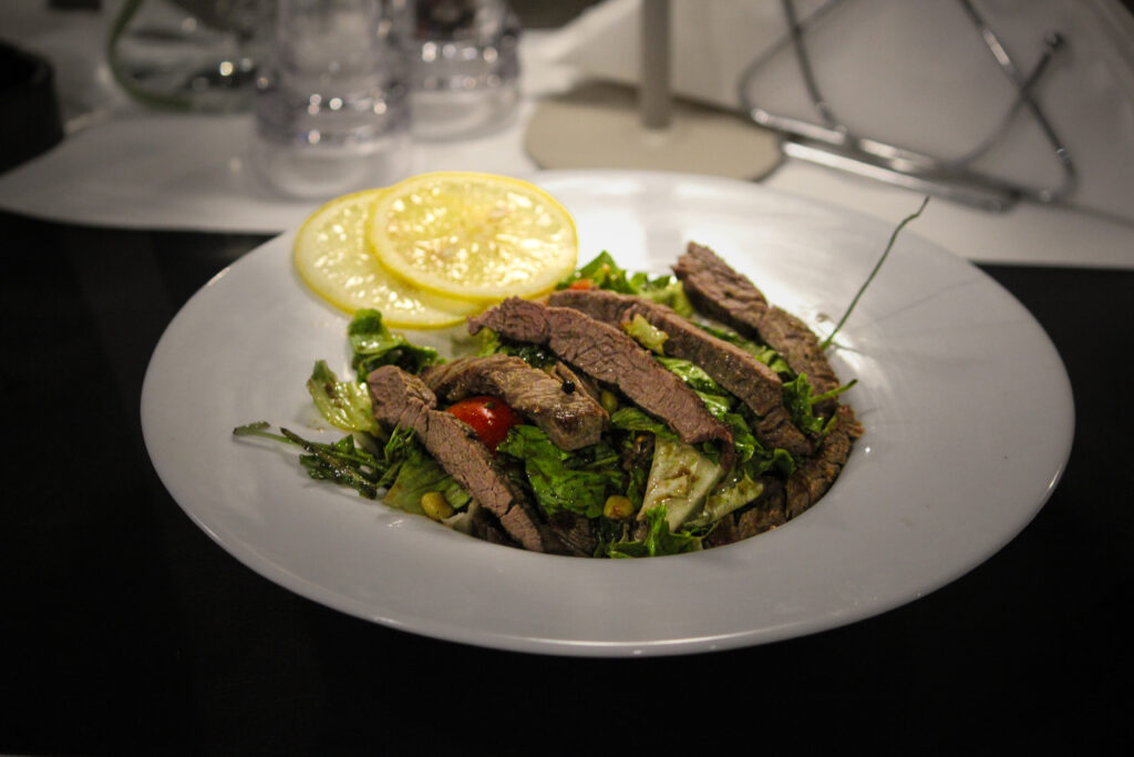 meat served on a plate with lemons
