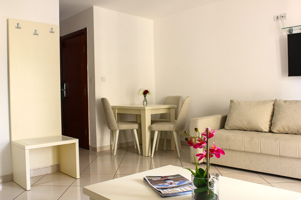 a table with chairs and sofa in a hotel room