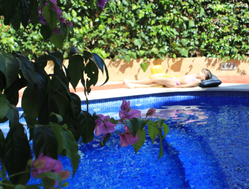 a kid relaxing by the pool