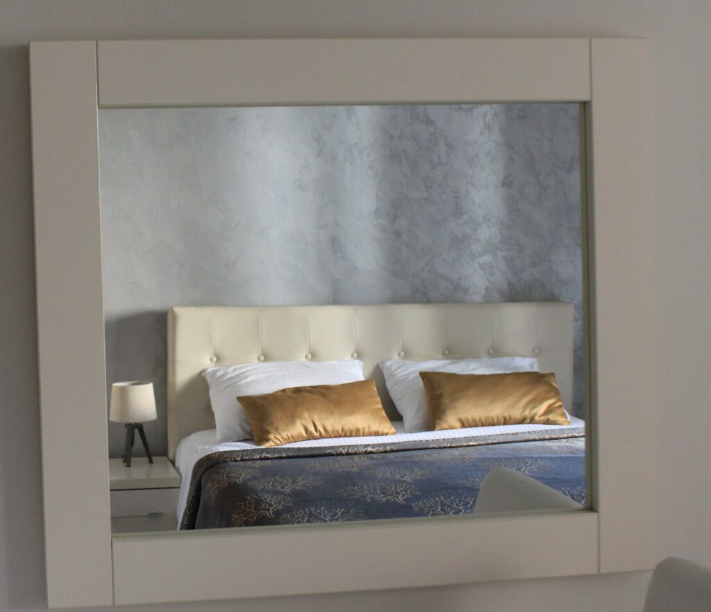 king size bed in mirror of a closet