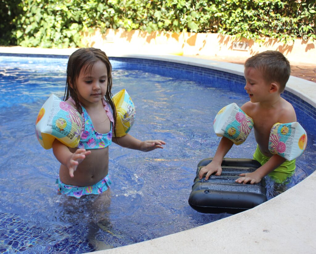 kids standing in the pool