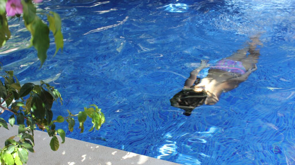 a kid diving in the pool