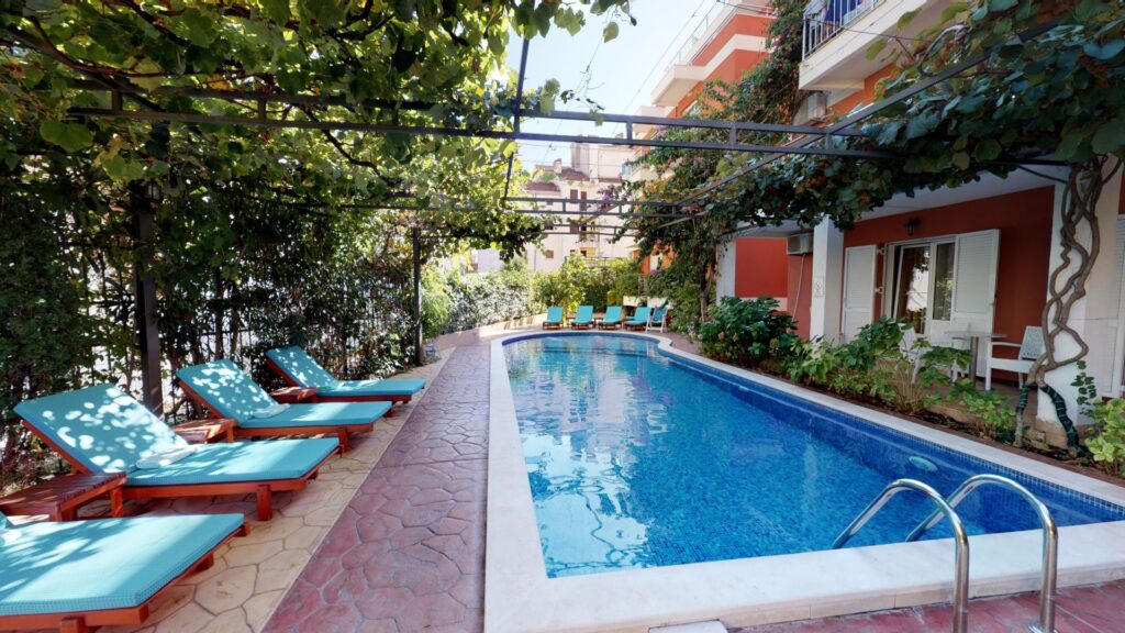 pool and sunbeds in hotel garden