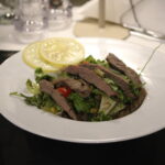 steak salad served with lemon
